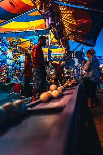 person group of people standing beside market lighting