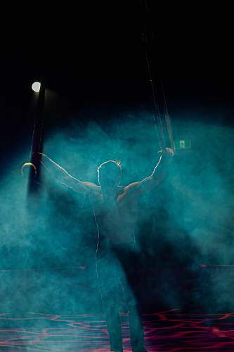 person man raising his hands performing lighting