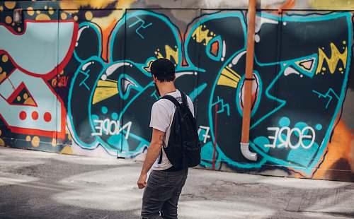 graffiti man wearing black backpack people