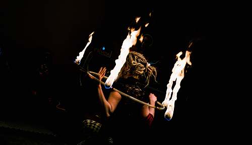 person woman holding hula-hoop with fire people