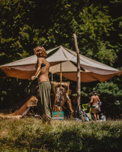 person woman standing near umbrella tent
