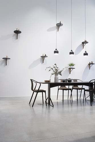 table black dining set near white wall black-and-white