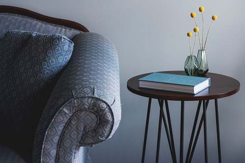 furniture blue book on round brown end table near sofa home