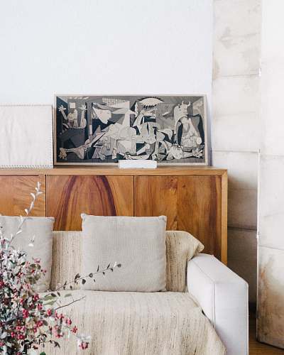 mexico brown wooden sideboard beside beige fabric sofa art