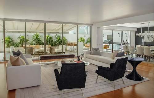home two black suede armchairs during daytime furniture