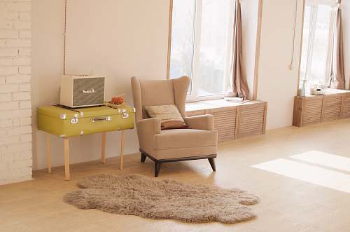 chair wing chair beside suitcase and window suitcase