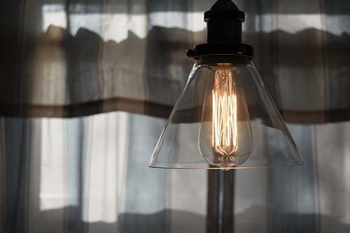 glass shallow focus photography of pendant lamp home