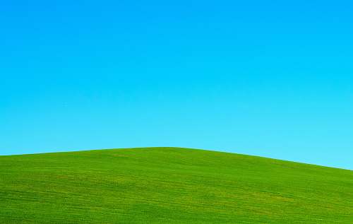 outdoors green hill under blue sky green