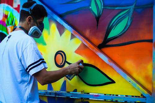 graffiti man paint flower on wall spray