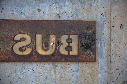 rust brown bus signage installed on wall vintage