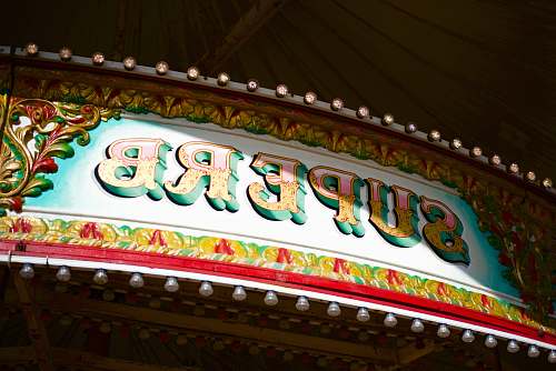 text green, red, and yellow floral Super signage superb