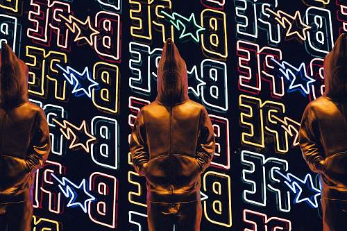 poster person standing in front of LED light neon