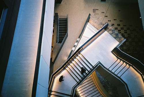 architecture closeup photo of two person on stair building