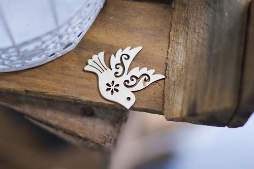 ornament gray bird cutout decor on brown plank peace