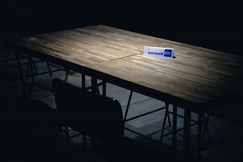 furniture white and blue reserved signage on brown table chair
