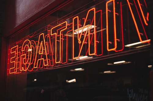 sign red neon signage on glass wall neon