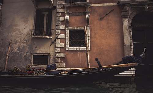 venice boat near concrete structure gondola