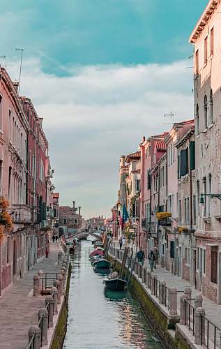 canal body of water between concrete buildings outdoors