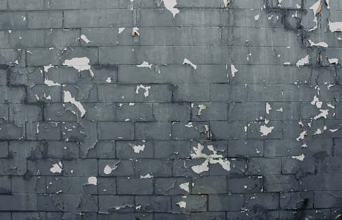 person gray concrete brick wall grey