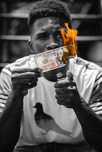 person grayscale photo of man holding a banknote finger