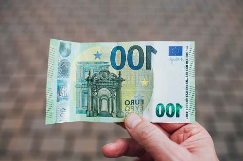 person person holding 50 euro bill book