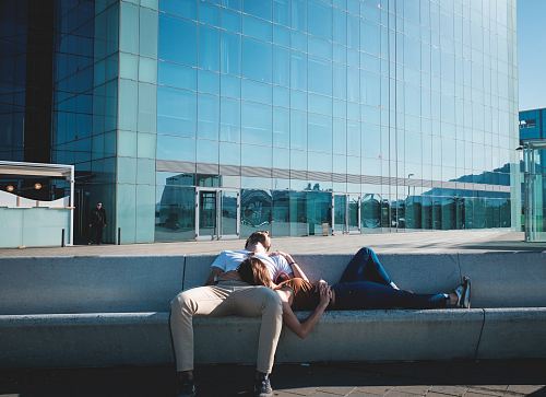 man and woman laying on concrete stairs