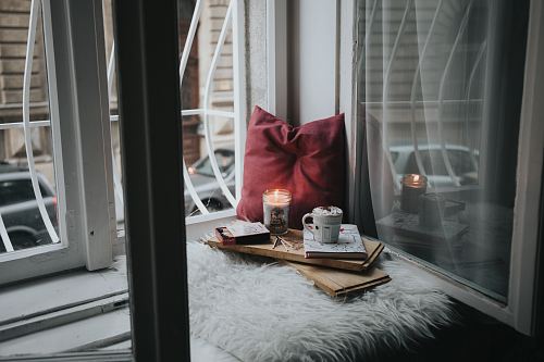 photo of gel candle on board beside pillow