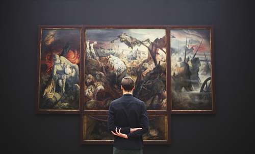 people man hands on back looking on painting mounted at wall person
