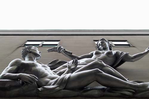 sculpture statue of nude woman and man on building human