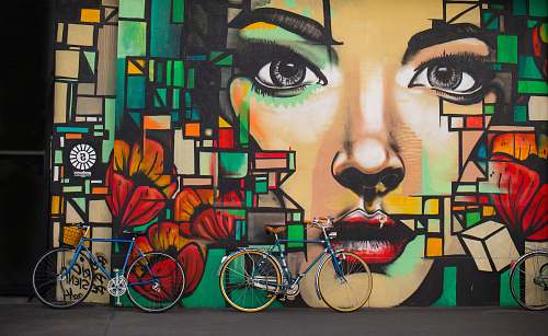 graffiti two blue cruiser bicycles on graffiti wall bike
