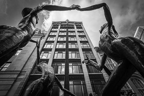 art grayscale photography of statues near building sculpture