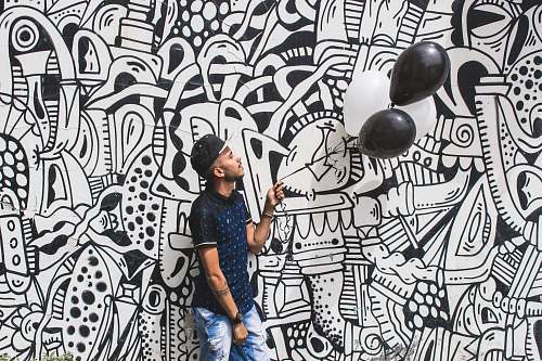 doodle man holding two black balloons human