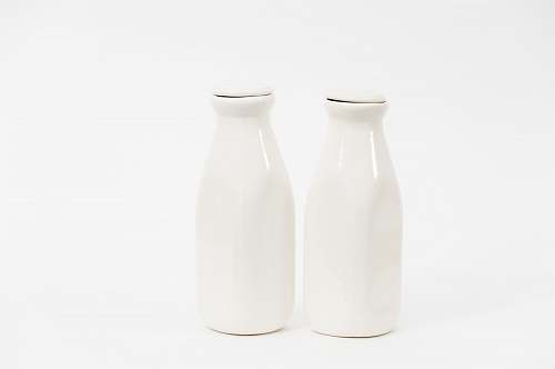 pottery two white milk bottles grey