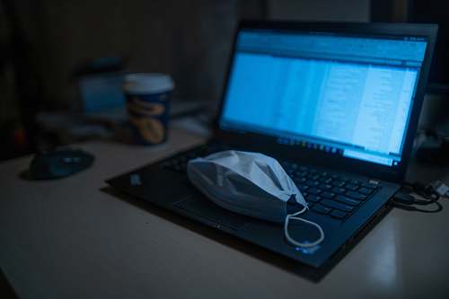 electronics black laptop computer beside black framed eyeglasses on brown wooden table computer