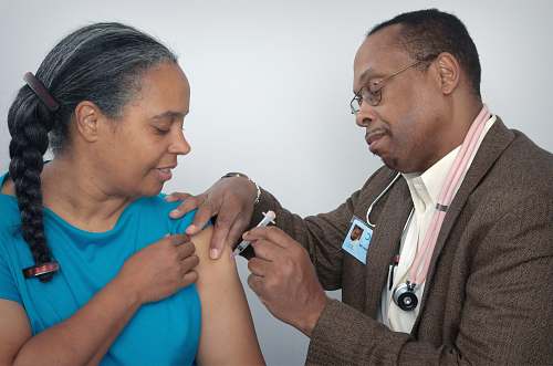 human man doing syringe on woman wearing blue shirt overcoat