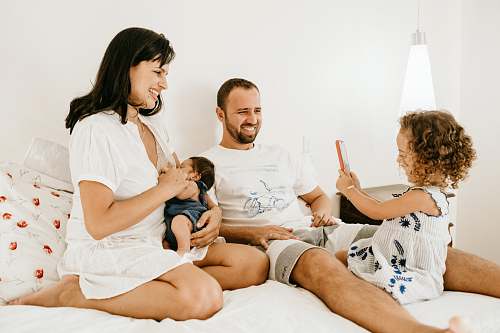  man in white crew neck t-shirt sitting beside woman in white crew neck t-shirt 