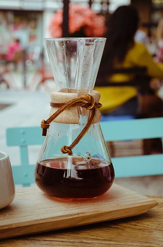 clear glass vase with brown liquid