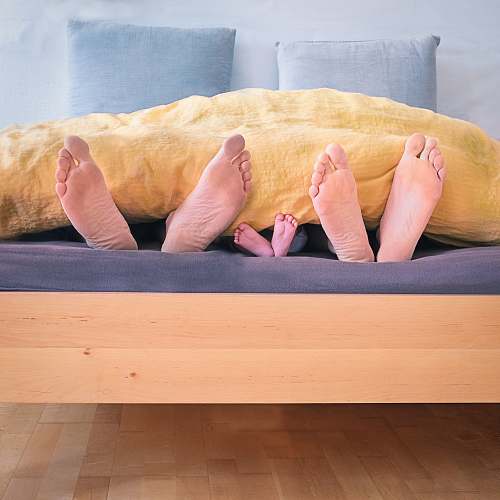 sleep three people underneath yellow bed blanket feet