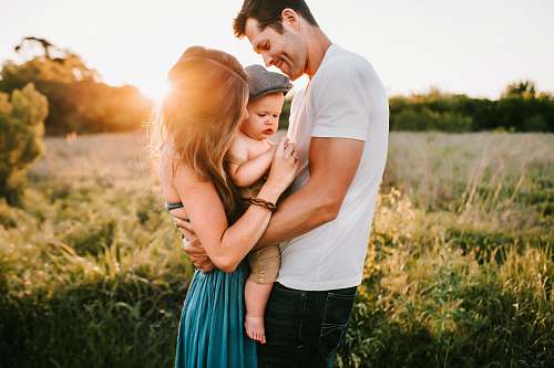 family family photo on green grass during golden hour person