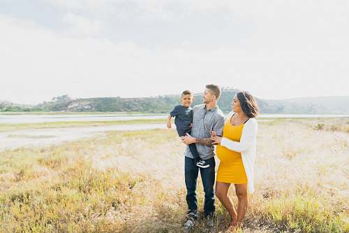 person man and woman standing outdoors family
