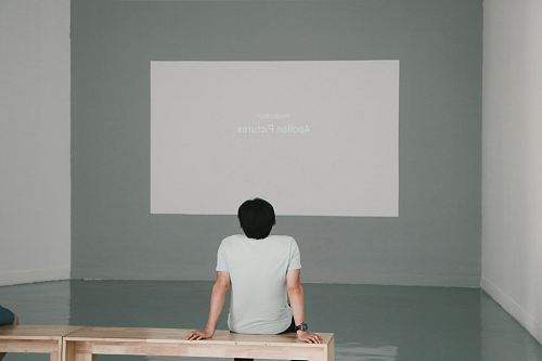 man sitting on bench inside room