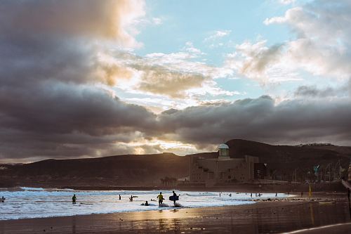 people on beach during sunset