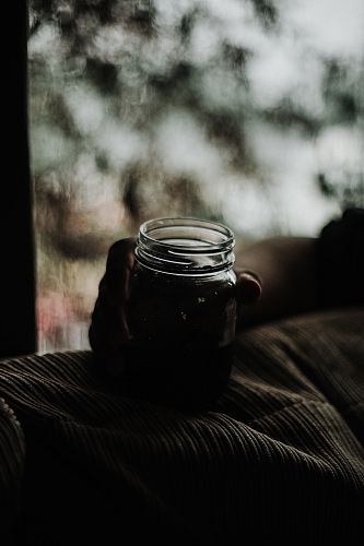 person holding glass jar