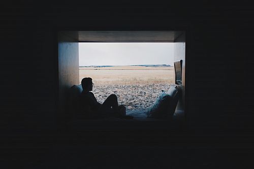 person sitting while looking outside