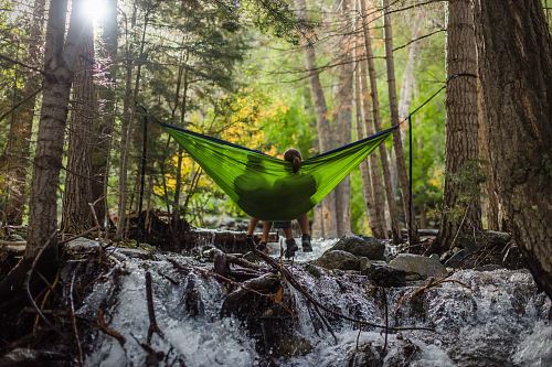 two person on green mesh hammock outdoor