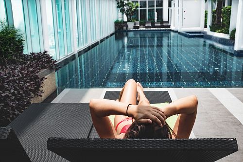 woman laying on brown chaise lounge