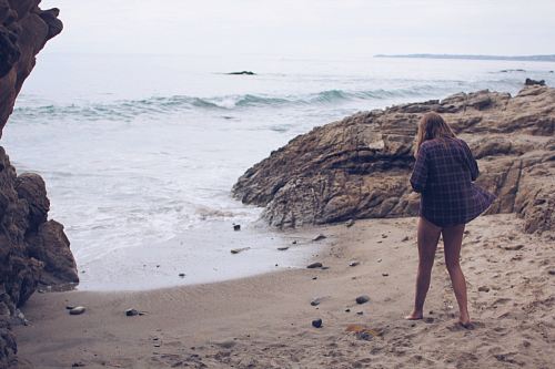 Woman on vacation steps out of the cove to relax in the beach shores