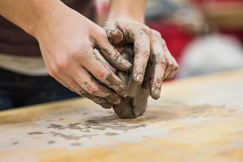 hands A clay stained hand of a potter engaging in a craft work of pottery or molding work