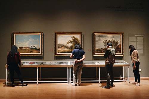 person people standing in front of paintings human