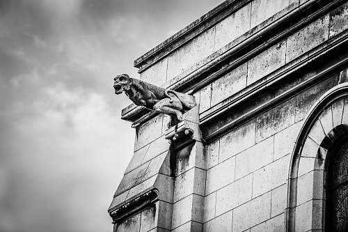sculpture statue outside building black-and-white